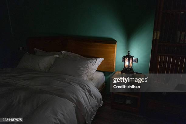 cozy bedroom scene with warm lighting and rustic decor. - cozy bedroom stock pictures, royalty-free photos & images