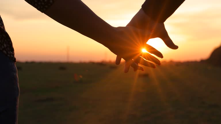 https://media.gettyimages.com/id/2234510813/video/the-man-and-woman-have-their-hands-clasped-tightly-at-sunset-slow-motion.jpg?b=1&s=640x640&k=20&c=QmeWJOuJer3ScUxwr98XsYcIbf4x71i54s9ZIM00isI=