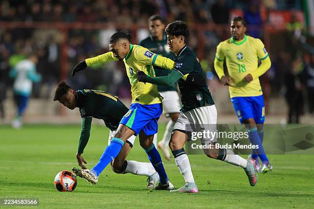 Raphinha of Brazil is challenged by Yomar Rocha and Miguel Terceros of Bolivia during the South American FIFA World Cup 2026 Qualifier match between...