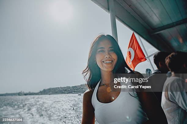 young woman on a ferry to istanbul, enjoying the view, perfect for travel photography, cityscape, tourism, lifestyle, adventure, vacation, and cultural exploration visuals. - türkische kultur stock-fotos und bilder