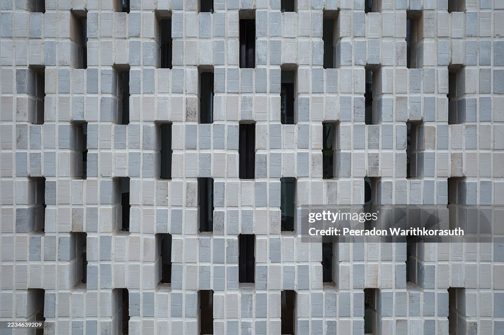 Symmetrical pattern of a modern perforated breeze block screen wall.