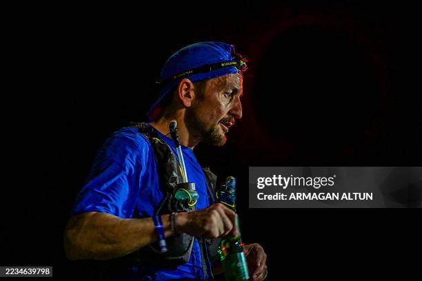 Runner stops at a supply station during the night stage of the Runfire Salt Lake '25 Ultramarathon in Salt Lake, Eskil - Aksaray, Turkey on August...