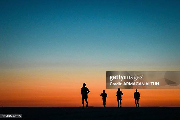 Athletes run across the white salt flats during the Runfire Salt Lake '25 Ultramarathon in Salt Lake, Eskil - Aksaray, Turkey on August 22, 2025. The...