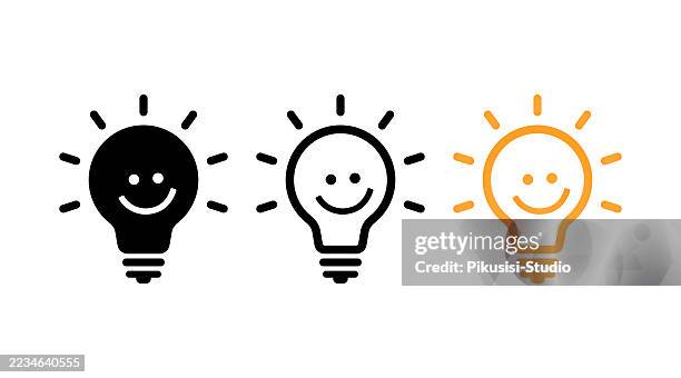 smiling light bulb icons set for ideas and creativity concept - edison light bulbs stock illustrations