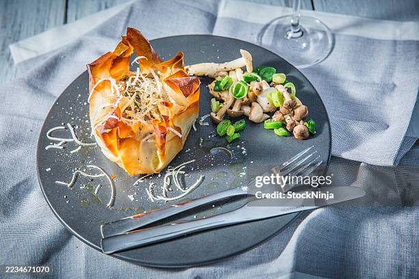 delicious phyllo dough pastry with fresh mushroom topping and garnish - fusion food stock pictures, royalty-free photos & images