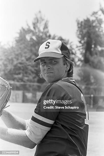 View of American actor John Ritter as he prepares to pitch a baseball, Los Angeles, California, circa 1977.