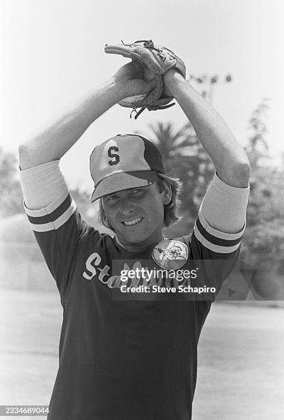 View of American actor John Ritter as he prepares to pitch a baseball, Los Angeles, California, circa 1977.