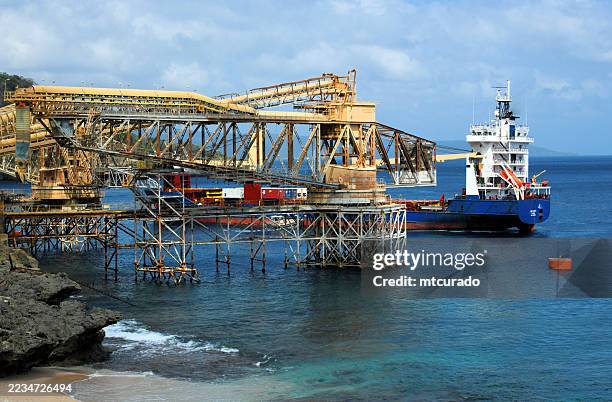 phosphate industry - cantilever loading system and freighter ship at flying fish cove wharf - christmas island - cantilever of a crane stock pictures, royalty-free photos & images