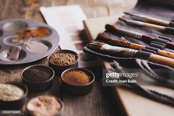 the artist uses natural pigment powder for their creation - artists palette stock pictures, royalty-free photos & images
