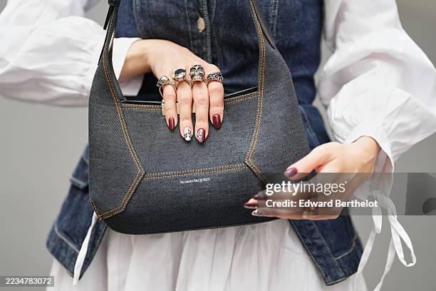 Marion Felicite wears a dark blue denim corset by & Other Stories layered over a white long-sleeve shirt dress by Sister Jane, a dark blue denim...