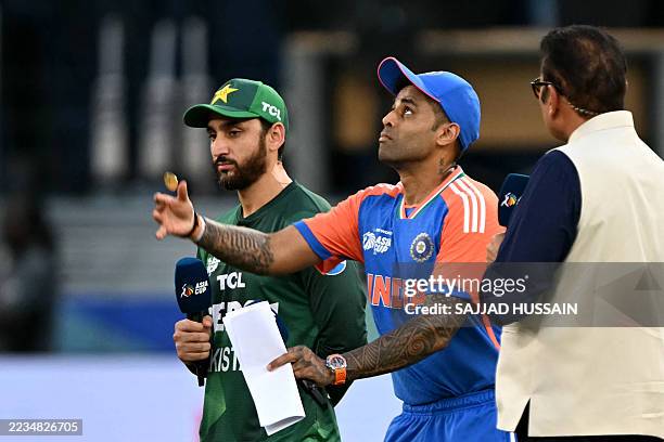 India's captain Suryakumar Yadav tosses the coin at the start of the Asia Cup 2025 Twenty20 international cricket match between India and Pakistan at...