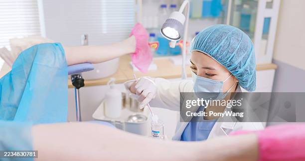 asian obgyn perform pap smear female patient - colposcopy stock pictures, royalty-free photos & images