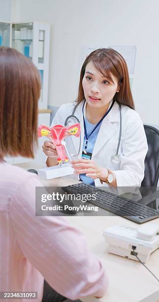 woman doctor explains cervical cancer to patient - colposcopy stock pictures, royalty-free photos & images