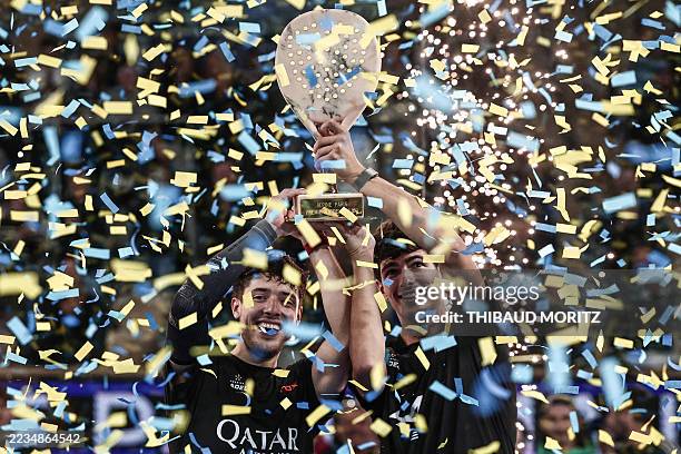 Spain's Arthuro Coello and Argentina's Augustin Tapia celebrate with the trophy after winning the men's final match of the Paris Major Premier Padel...