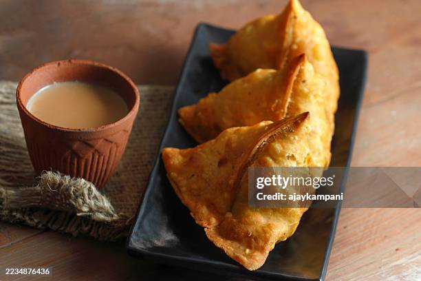 tea with samosas - samosa stock pictures, royalty-free photos & images