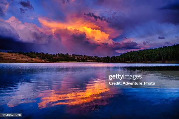 sunset thunderstorm reflected on deep lake, flat tops wilderness, colorado - colorado mountains stock pictures, royalty-free photos & images