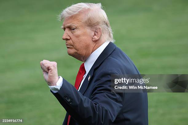 President Donald pumps his fist after taking questions from reporters on slain conservative activist Charlie Kirk while departing the White House on...