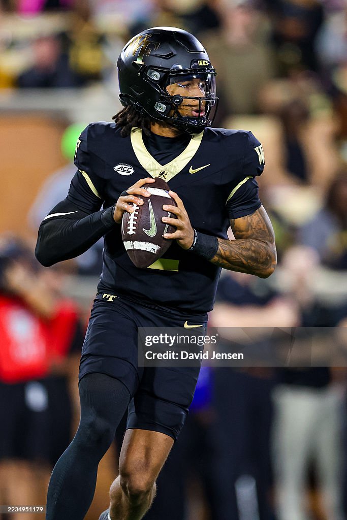 Robby Ashford of the Wake Forest Demon Deacons looks to pass the