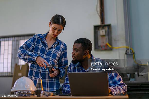 blue collar workers are working at machine shop. - new skill stock pictures, royalty-free photos & images