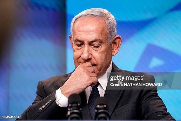 Israel's Prime Minister Benjamin Netanyahu reacts during a joint press conference with the US Secretary of State at the Prime Minister's Office in...