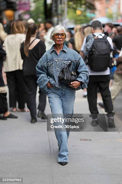 Grece Ghanem is seen wearing a Calvin Klein denim jacket, denim jeans, black heels, a black handbag and orange tinted sunglasses on September 12,...