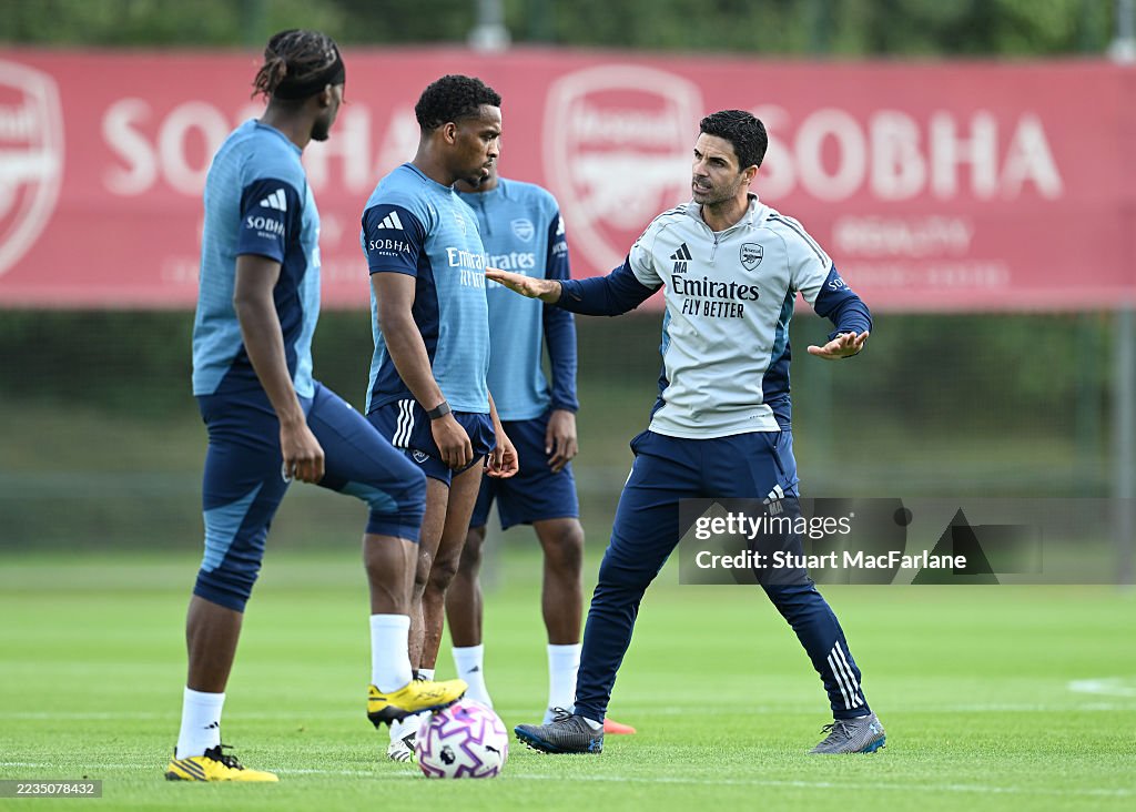 Arsenal Training Arsenal manager Mikel Arteta talks to Jurrien Timber during a... News ...