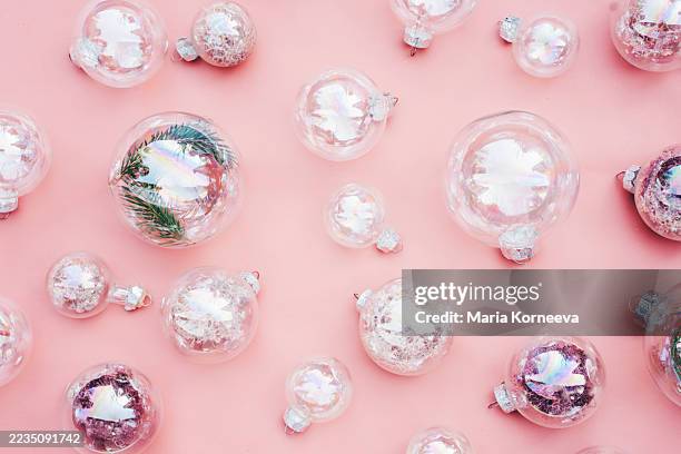 christmas transparent balls on pink background. - arte minimalista fotografías e imágenes de stock