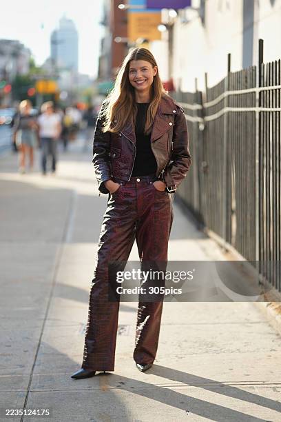 Mathilde Henning is seen wearing a Gestuz red leather biker jacket in a crocodile pattern, matching red leather pants, black tee and black heels...