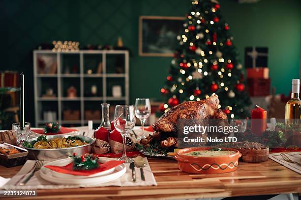 christmas dinner table with turkey and festive decorations - dining table stock pictures, royalty-free photos & images
