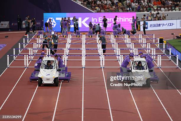 Officials lay out the hurdles for the Women's Final during the World Athletics Championships 2025 at the National Stadium in Tokyo, Japan, on...