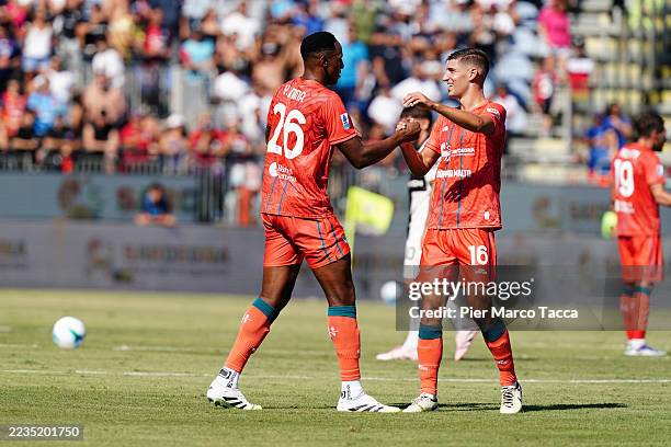Yerry Mina of Cagliari Calcio elebrates with his team mate Matteo Prati after scoring his first goal during the Serie A match between Cagliari Calcio...