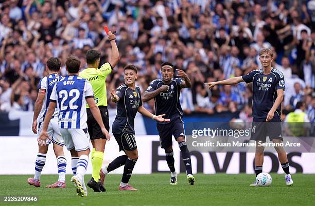 Dean Huijsen of Real Madrid is shown a red card by referee during the LaLiga EA Sports match between Real Sociedad and Real Madrid CF at Reale Arena...