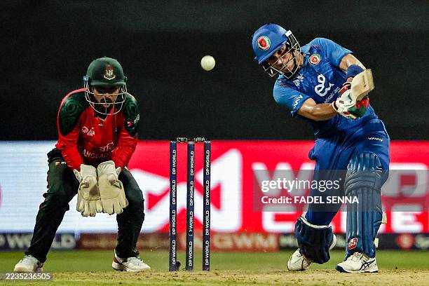 Afghanistan's Rahmanullah Gurbaz plays a shot as Bangladesh's wicketkeeper and captain Litton Das reacts during the Asia Cup 2025 Twenty20...