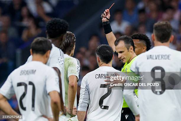 Real Madrid's Spanish defender Dani Carvajal is ejected with a red card after head butting Marseille's Argentine goalkeeper Geronimo Rulli during the...