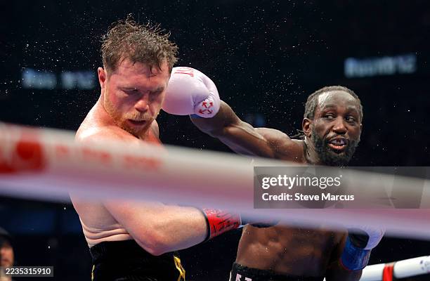 Canelo Alvarez takes a punch from Terence Crawford in their undisputed super middleweight title fight during Netflix's Canelo v Crawford Fight Night...