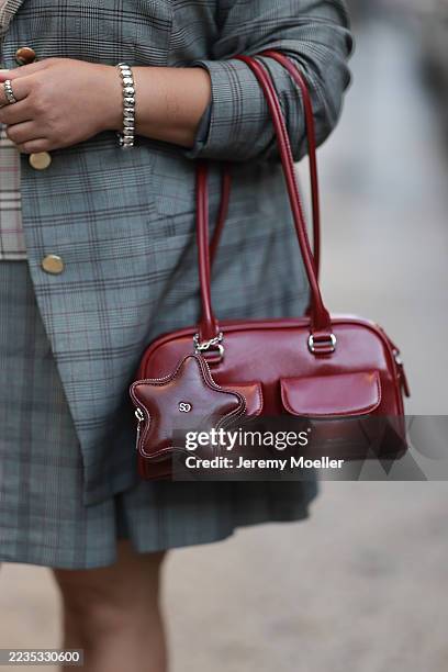 Greivy seen wearing Eloquii blazer featuring rolled-up sleeves, layered over a matching grey plaid Ann Taylor lace-up vest, and paired with a pleated...