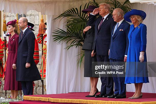 President Donald Trump salutes as he stands beside King Charles III and Queen Camilla with Melania Trump during the national anthem as Catherine,...