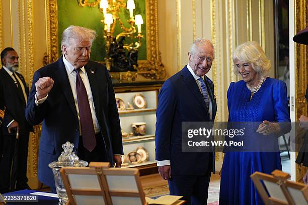 President Donald Trump, King Charles III and Queen Camilla view items on display during a visit to the Royal Collection exhibition, in the Green...