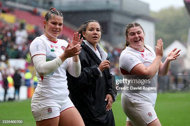 Jess Breach, Tatyana Heard and Maud Muir of England applaud the crowd following victory in the Women's Rugby World Cup 2025 Quarter Final match...