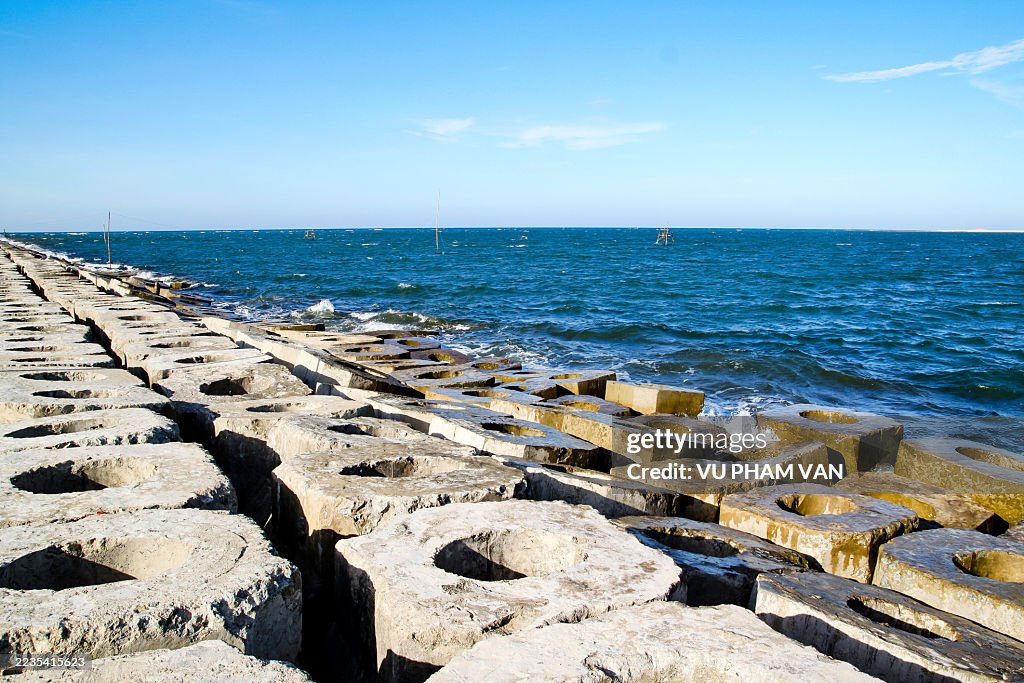 Breakwaters constructed from concrete blocks along coastline
