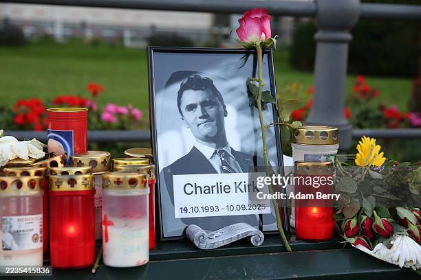 Flowers and candles are seen at a makeshift memorial for murdered American conservative activist Charlie Kirk outside the U.S. Embassy as its flag...