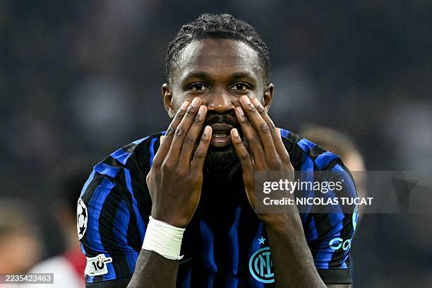 Inter Milan's French forward Marcus Thuram celebrates scoring his team's second goal during the UEFA Champions League first round day 1 football...
