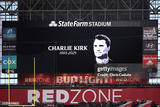 The video board shows a tribute to Charlie Kirk prior to a game between the Carolina Panthers and the Arizona Cardinals at State Farm Stadium on...