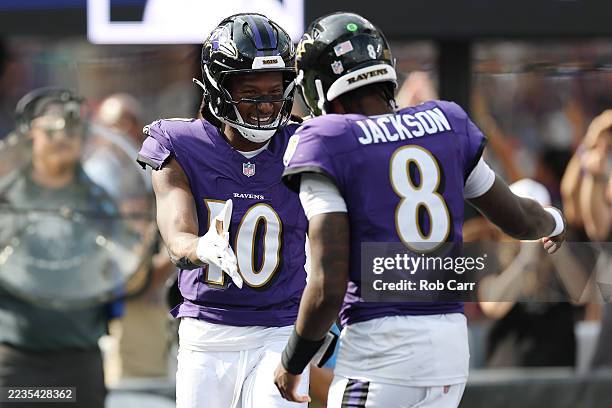 DeAndre Hopkins and Lamar Jackson of the Baltimore Ravens react after a fourth quarter touchdown during a game against the Cleveland Browns at M&T...