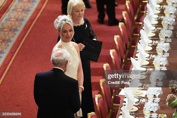 English professional golfer Charley Hull, center, attends a State Banquet hosted by King Charles III and members of the Royal Family at Windsor...