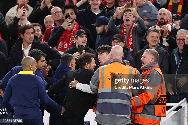 Diego Simeone, Manager / Head Coach of Atletico Madrid is restrained as he confronts fans after the late Liverpool winning goal during the UEFA...