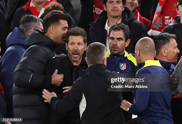 Diego Simeone, Manager / Head Coach of Atletico Madrid is restrained as he confronts fans after the late Liverpool winning goal during the UEFA...