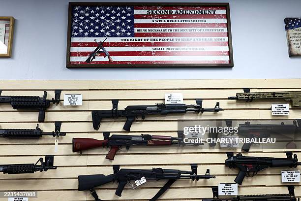 The second amendment is spelled on a US flag above a display of firearms for sale in a gun store in Rio Rico, Santa Cruz County, Arizona on September...