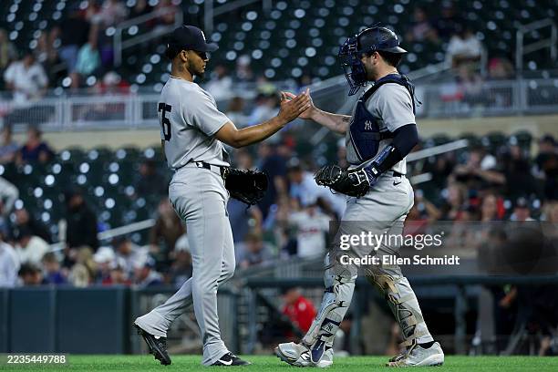 Camilo Doval and Ben Rice of the New York Yankees celebrate a 10-5 win against the Minnesota Twins at Target Field on September 17, 2025 in...
