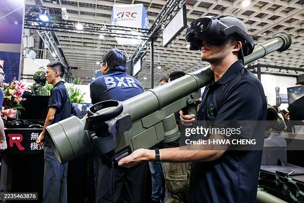 Staff member holds a Stinger missile at the booth of Global Power technology during the Taipei Aerospace & Defense Technology Exhibition in Taipei on...